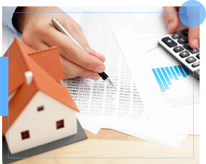 A person writing on paper with a house and calculator in front of them.